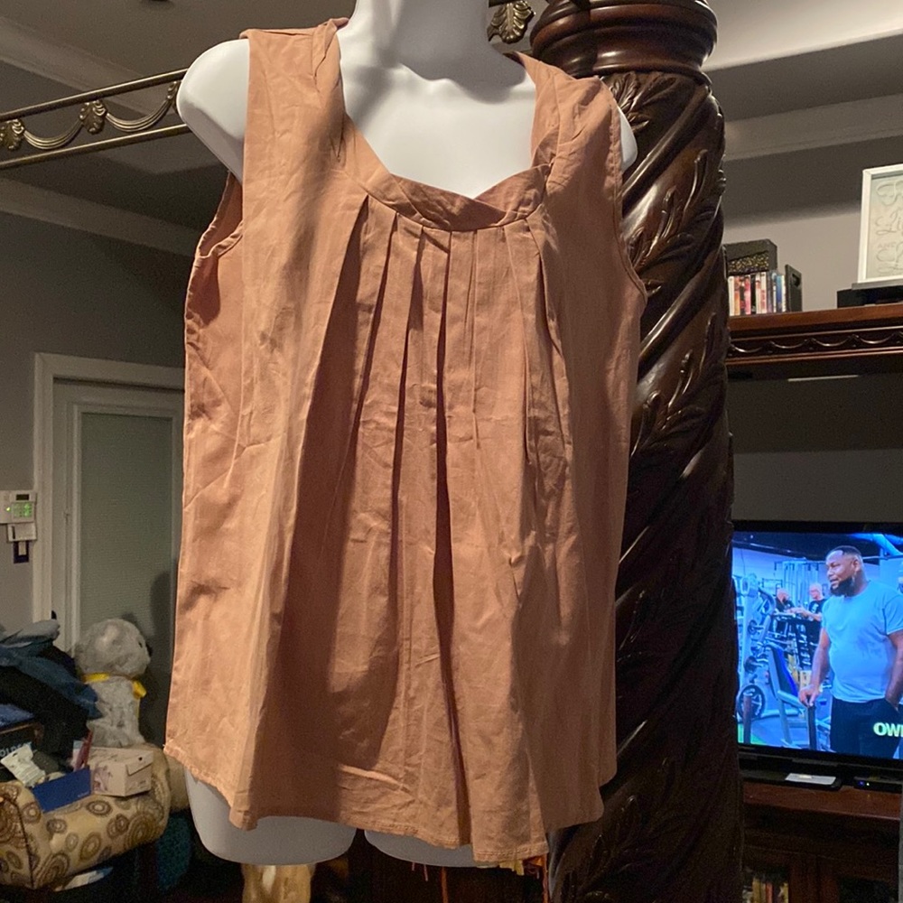 Gently worn. Tan sleeveless shell